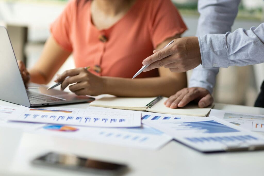 Business accountants are coaching laptop-based apprentices on tax systems.